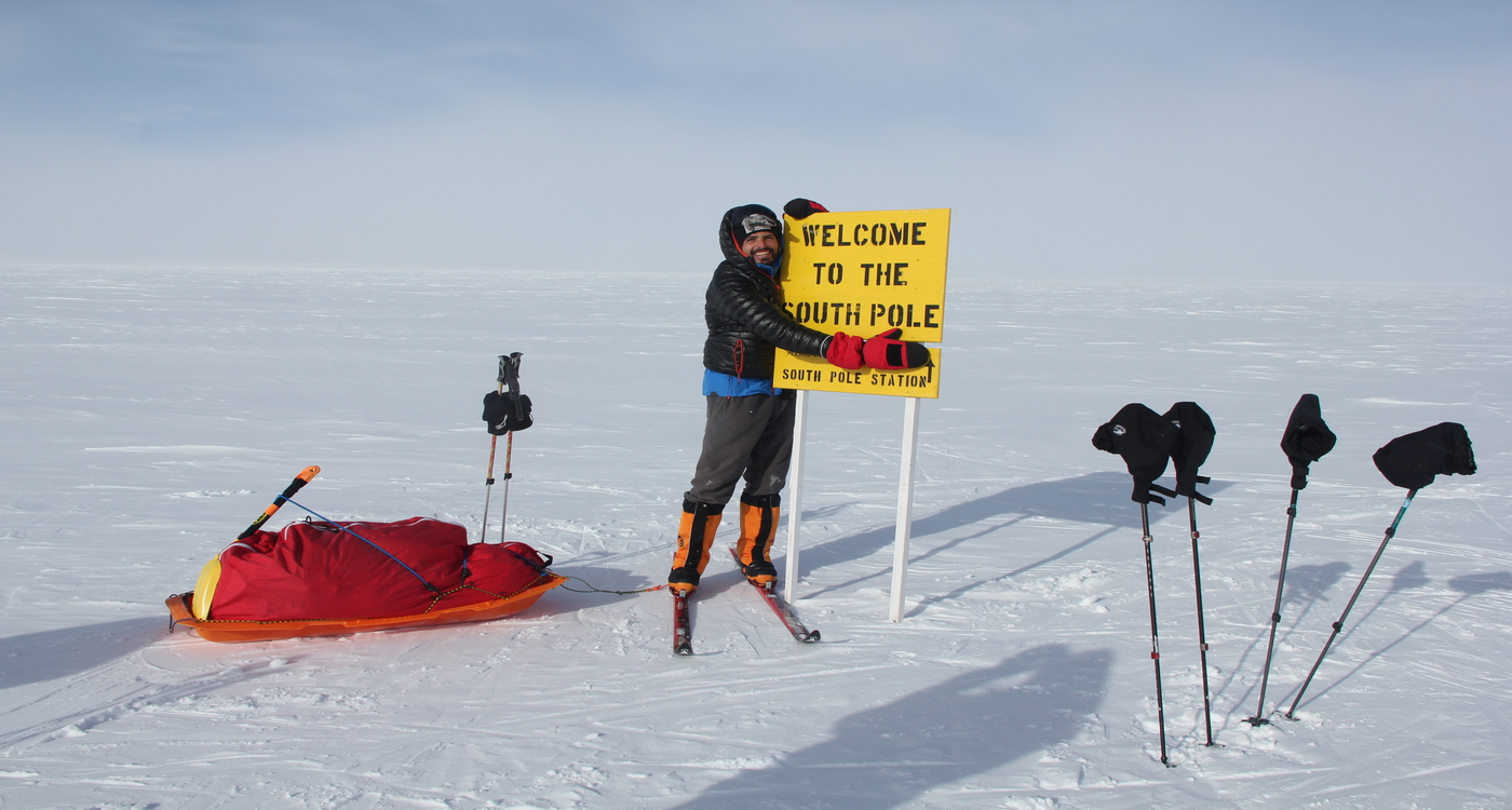 South Pole camp sign post hug